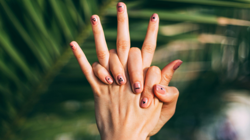 An Image of a woman holding her own hand to indicate self love.